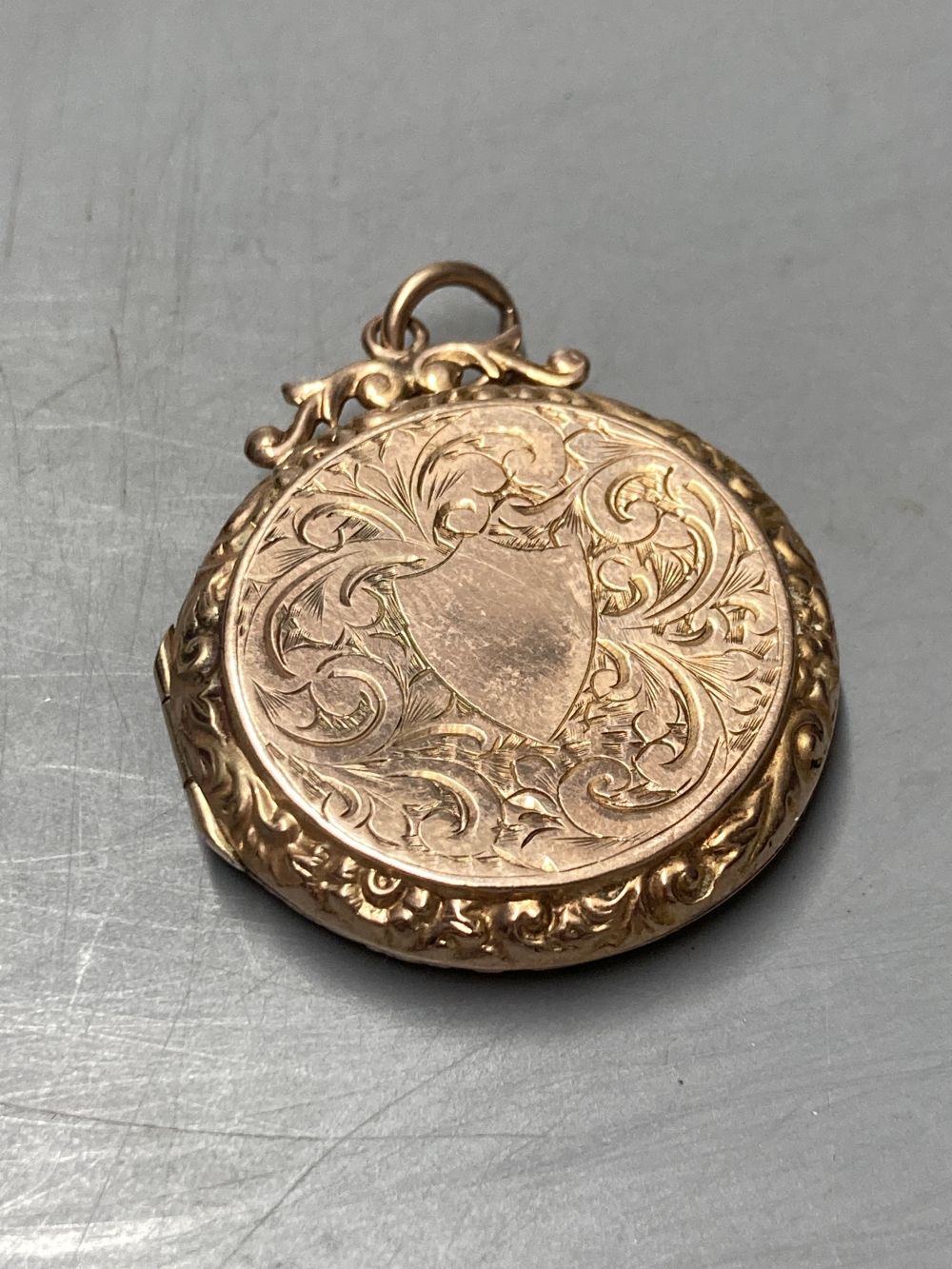 Two gold plated overlaid and gem set fob seals, largest 35mm, a 9ct front and back locket and a scroll brooch.